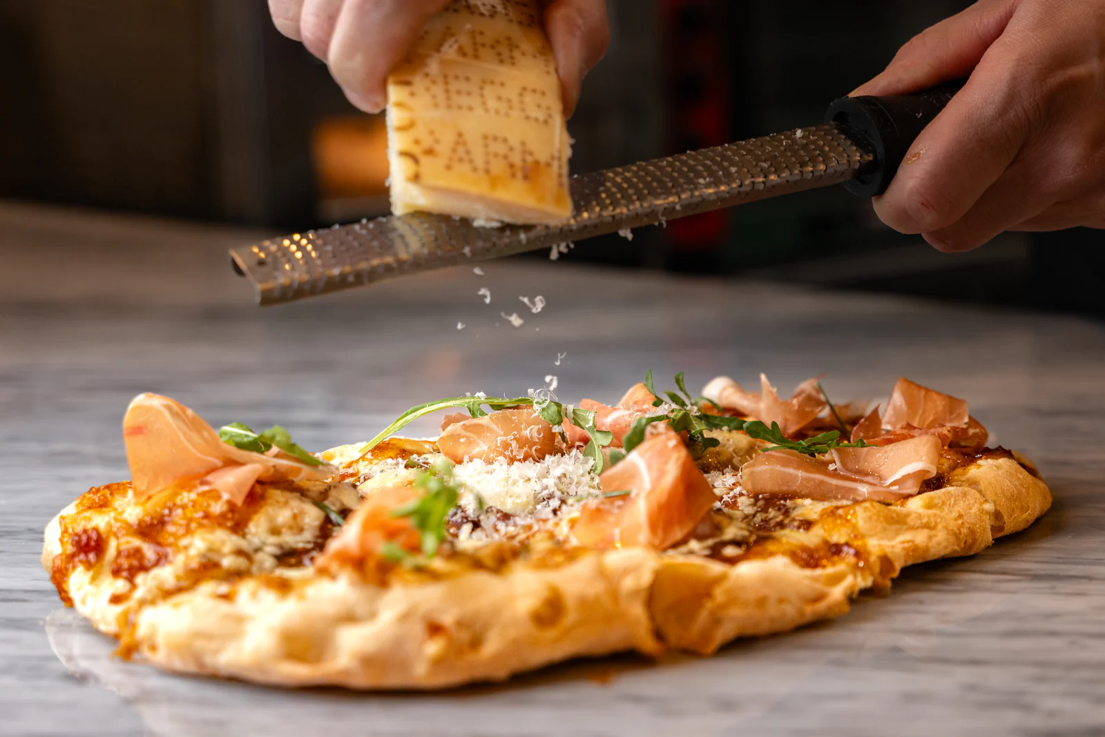Pizza finished with grated cheese