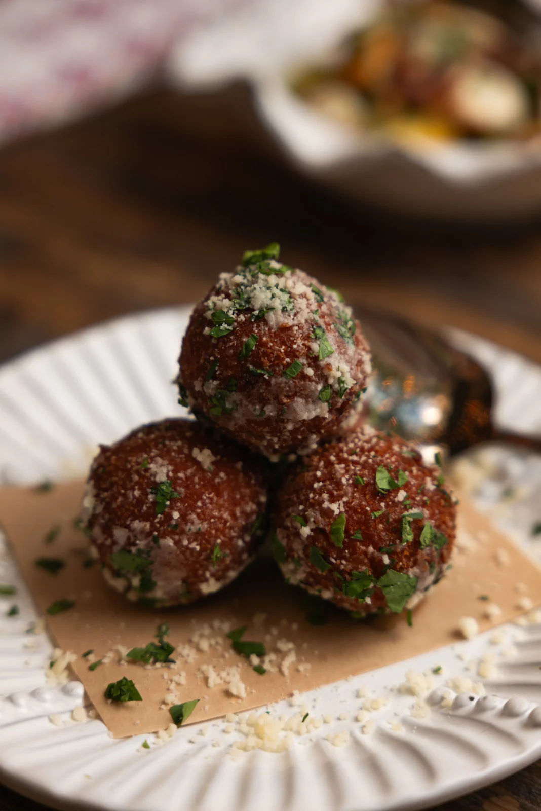 Meatballs plated with herbs and cheese