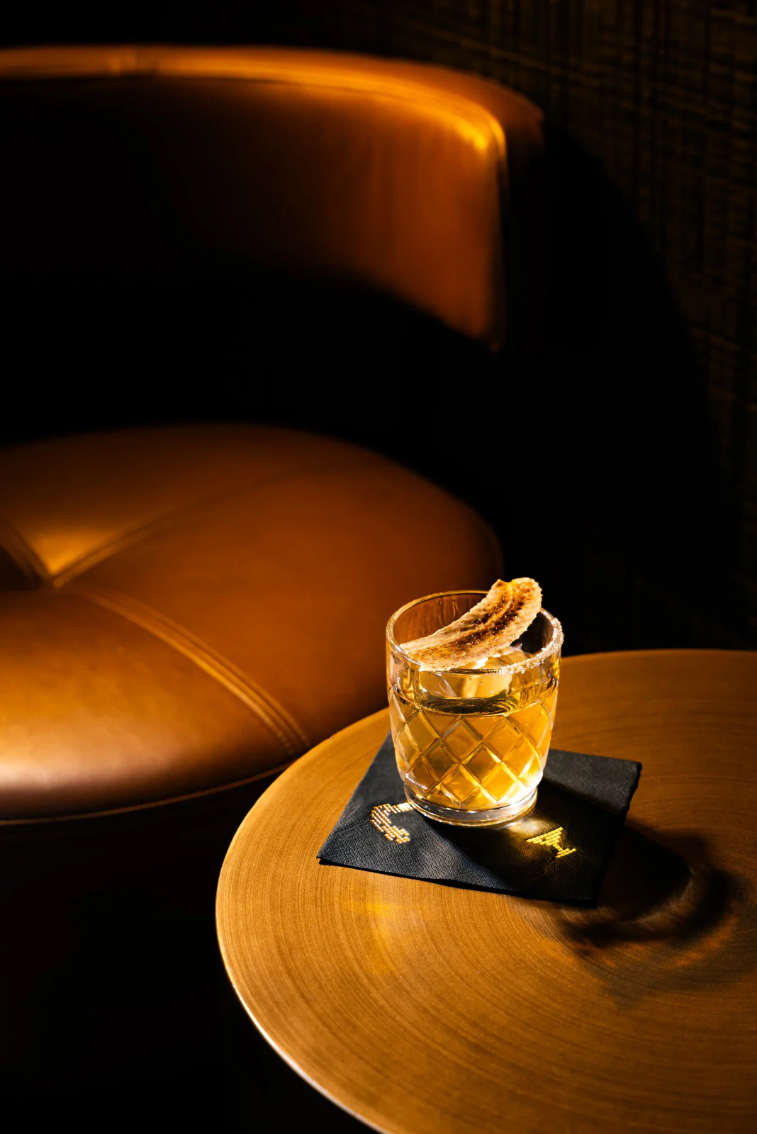 Cocktail with citrus garnish on a dark table